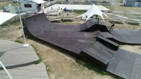 Cyclist performs tricks in skate park 스톡 동영상 103032449
