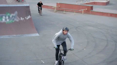 Cyclist performs tricks in skate park on the open air Video stock 103246178