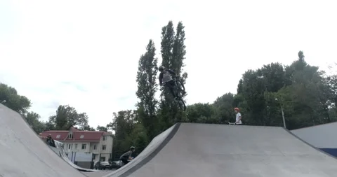 Cyclist performs tricks on slides in skate park 스톡 동영상 103025895