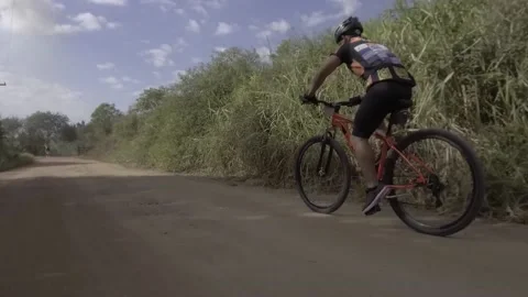 Cyclist practicing mountain biking. Cyclists speeding on dirt road. Stock Footage 216237734