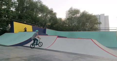 Cyclist is practicing tricks at skate park 스톡 동영상 103243656