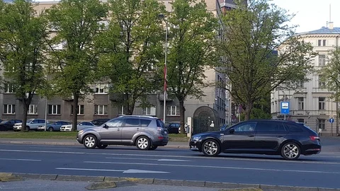 Cyclist in protective jacket rides by road past camera Stock Footage 116607406
