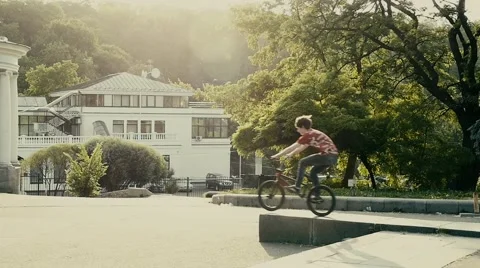 Cyclist pulls off the border in the park, slow motion  2 Stock Footage 51375506