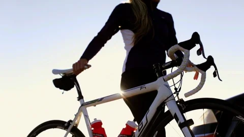 Cyclist pushing her bicycle. 스톡 동영상 88405143
