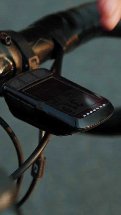Cyclist pushing start button on bike GPS navigation, close up. Vertical video Stock Footage 314672046