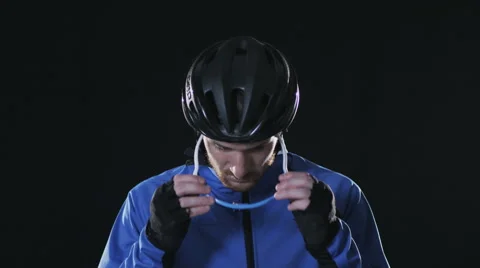 Cyclist putting on helmet Stock Footage 67672164