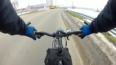 Cyclist quickly goes on  winter road in  city Stock Footage 22018814