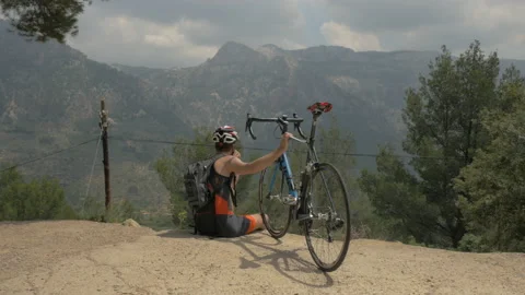 Cyclist Resting And Looking At Mountain Range In Mallorca Stock Footage 131842908
