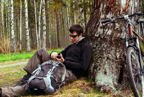 Cyclist resting in a tree Stock Photos