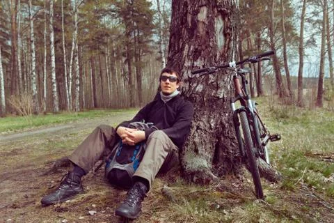Cyclist rests in the forest Stock Photos