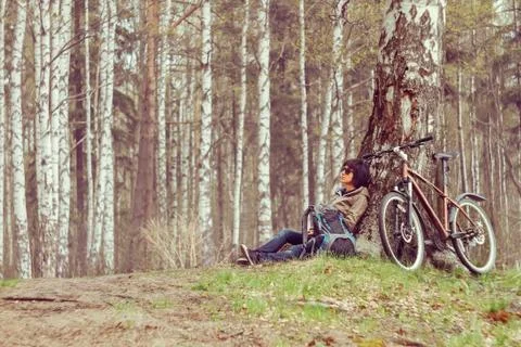 Cyclist rests in a forest Stock Photos