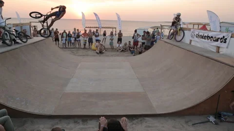 Cyclist Rides and Performs Extreme Jumps in Minirampe on Sunset Background Stock Footage 59893592