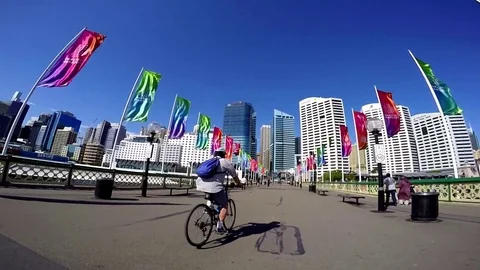 Cyclist rides on bridge linking Sydney's CBD to Darling Harbour Video stock 80095060