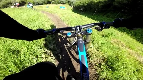 A cyclist rides down the mountain and falls Stock Footage 81048224