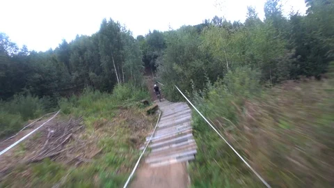 Cyclist rides in front of the camera jumps on ski jumps, action camera Stock Footage 116488193