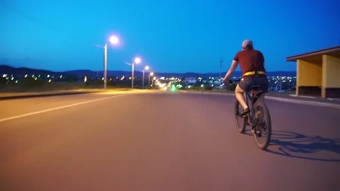 Cyclist rides on the highway Stock Footage 112989499