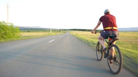 Cyclist rides on the highway Stock Footage 112989841