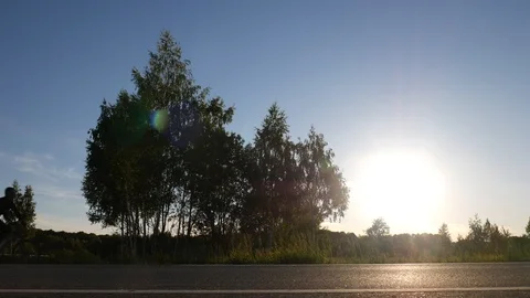 A cyclist rides from left to right at the sunset Stock Footage 91266219