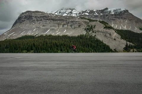 Cyclist rides in mountains - Banff, Alberta, Canada Stock Photos