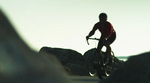 A cyclist rides past the camera Stock Footage 62890343