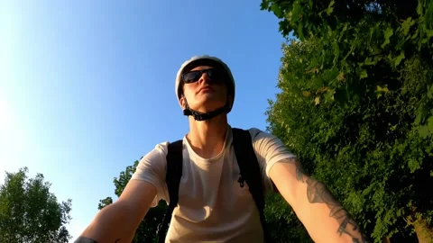 Cyclist rides on a path in a park in the summer among the trees. Bottom view 動画素材 169274737