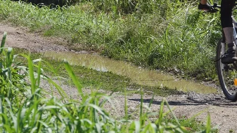 Cyclist rides on a puddle Video stock 116479584