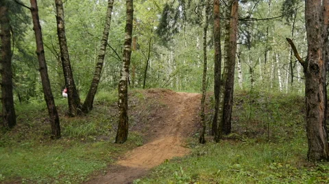 A cyclist rides on a small hill Stock Footage 65774069
