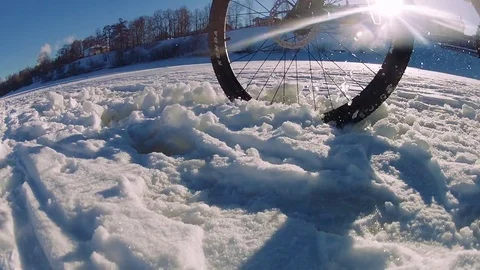 Cyclist Rides Through Soft Snow in Sunny Winter Day Video stock 73506670