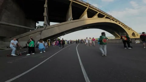 Cyclist rides under a bridge Video stock 204937370