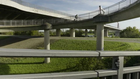 A cyclist rides up a winding road Stock Footage 220210812