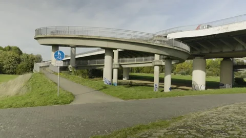 A cyclist rides up a winding road Stock Footage 220212375