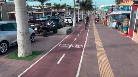 Cyclist riding along cycle path Main Street Corralejo 库存影片 221427079