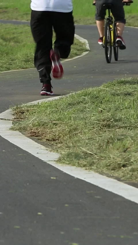 Cyclist riding and Road runner Male Legs Feet Running. Sports lifestyle Stock Footage 314818645
