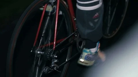 Cyclist riding a bicycle at night close-up Stock Footage 76495953
