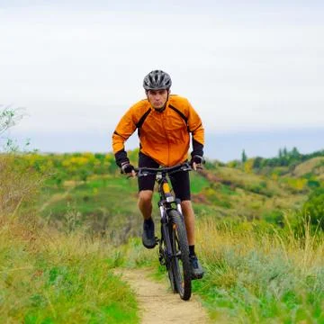 Cyclist Riding the Bike on Beautiful Spring Trail Stock Photos