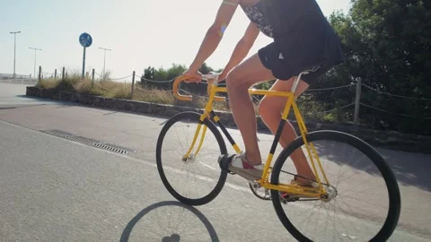 A Cyclist is Riding a Bright Yellow Bicycle on a Beautiful Sunny Pathway Stock Footage 288117325