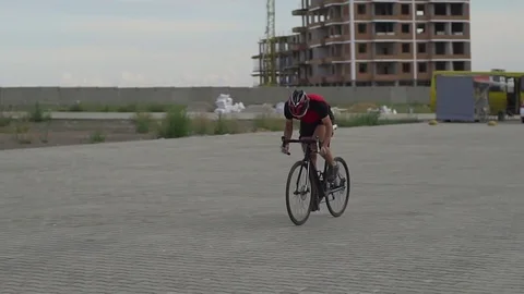Cyclist riding a construction site sunset rapid slow motion Video stock 85000662