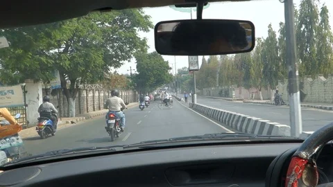 Cyclist riding crosses a road on wrong side View from inside a car Stock Footage 87469520