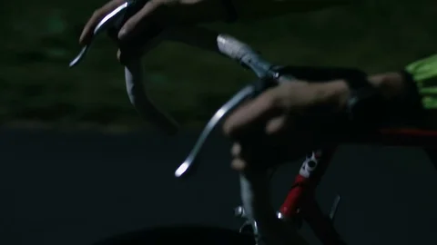 Cyclist riding at night close-up Stock Footage 76493659