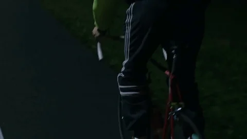 Cyclist riding at night close-up Stock Footage 76496953