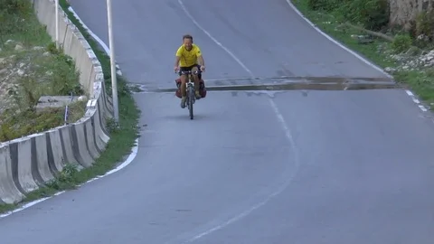 Cyclist riding on a paved road Stock Footage 71855923
