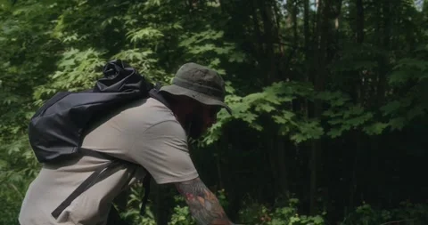 Cyclist riding through forest as camera moves closer Stock Footage 311919961