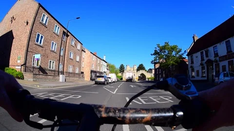 Cyclist riding through walmgate bar into the city of york united kingdom Stock Footage 108654306