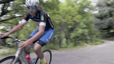 Cyclist riding uphill fast Stock Footage 115901622