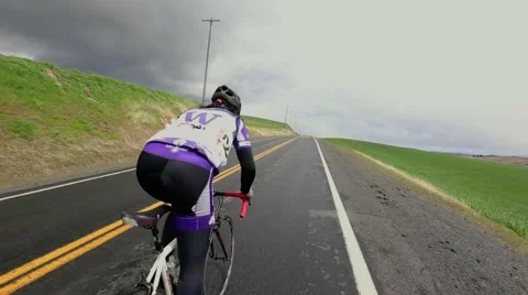 Cyclist riding uphill Stock Footage 50452653