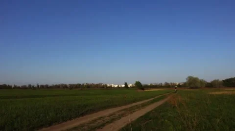 Cyclist on a rural road Stock Footage 56606815