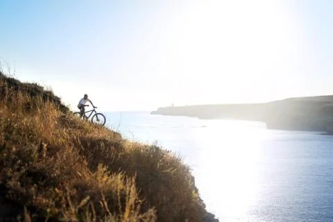 Cyclist on the seashore Stock Photos