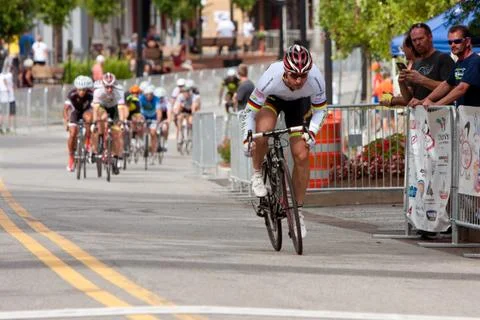 Cyclist separates himself from pack in criterium event Stock Photos