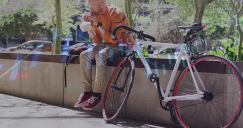 Cyclist settling on ledge after ride and eating sandwich during break with Video stock 312038811