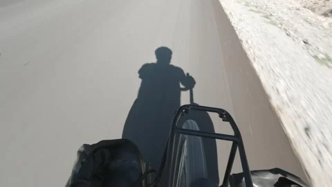 Cyclist shadow on asphalt during bicycle touring, symbolizing freedom, adve.. Stock Footage 328874804